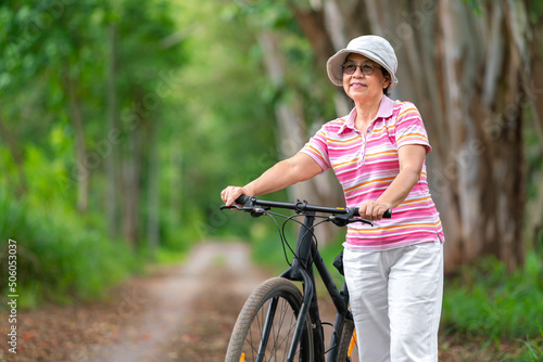 senior business woman, female, ride or bike mountain bicycle in country park near home town for healthy exercise in summer weekend