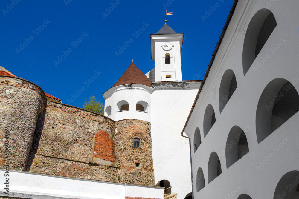 Fototapeta premium white clock tower of an ancient castle