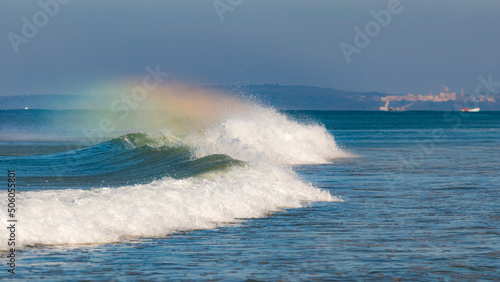 rainbows over waves on the sea