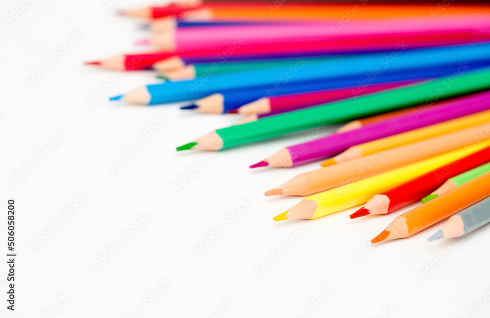 School stationery items. Creation Multicolored pencils on a blank white sheet. On a white background. Children's drawing, artist.
