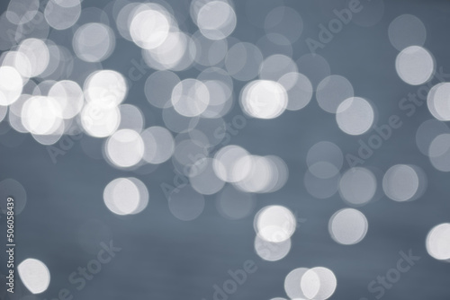 Lovely blurred bokeh effect image of specular highlights on lake during Summer sunny day photo