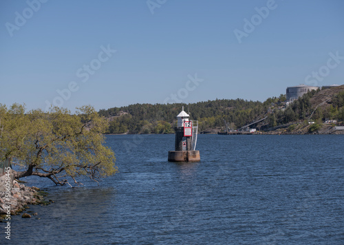 Photography Light house at the pike Blockhusudden with speed sign a sunny day in Stockholm