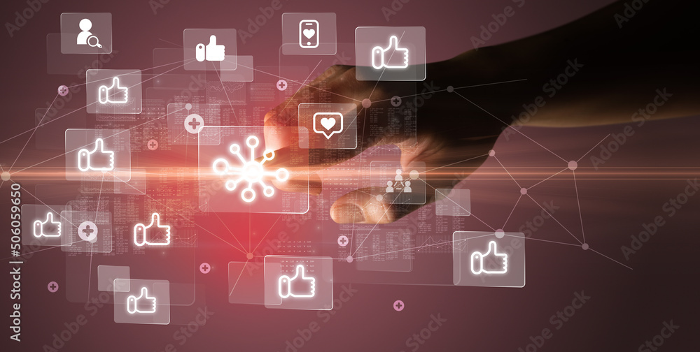 Hand pressing social media multimedia application screen with media icons on futuristic concept Hand pressing social media multimedia application screen with media icons on futuristic concept