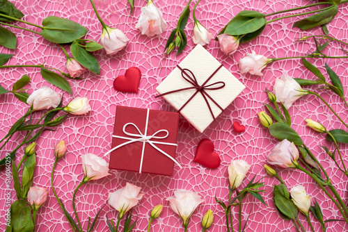 Gifts in the form of hearts on a pink background with the inscription love flower bouquet. Valentine's Day. Love background. Copy space for text. The concept of romance and love. March 8 women's Day.