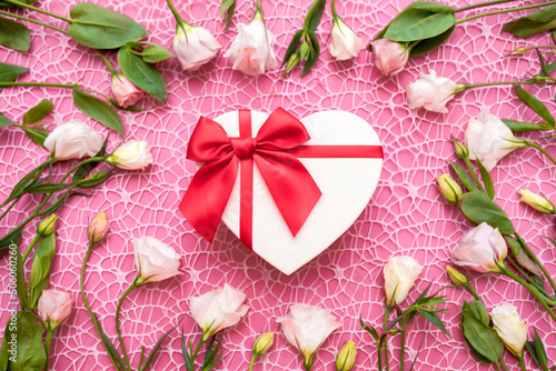 Fototapeta Naklejka Na Ścianę i Meble -  Gifts in the form of hearts on a pink background with the inscription love flower bouquet. Valentine's Day. Love background. Copy space for text. The concept of romance and love. March 8 women's Day.