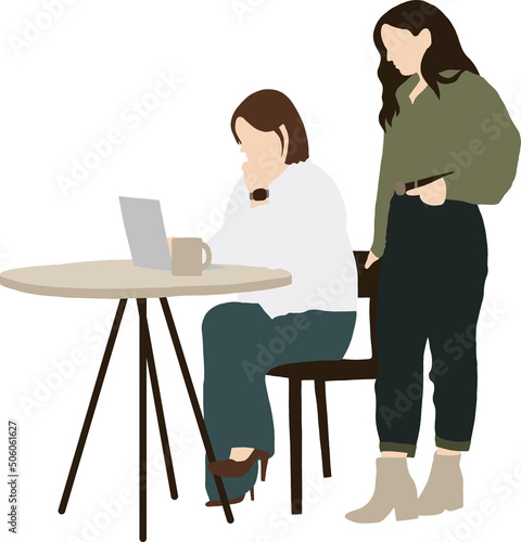 A girl is sitting at a table with a laptop, and a second girl colleague is standing next to her