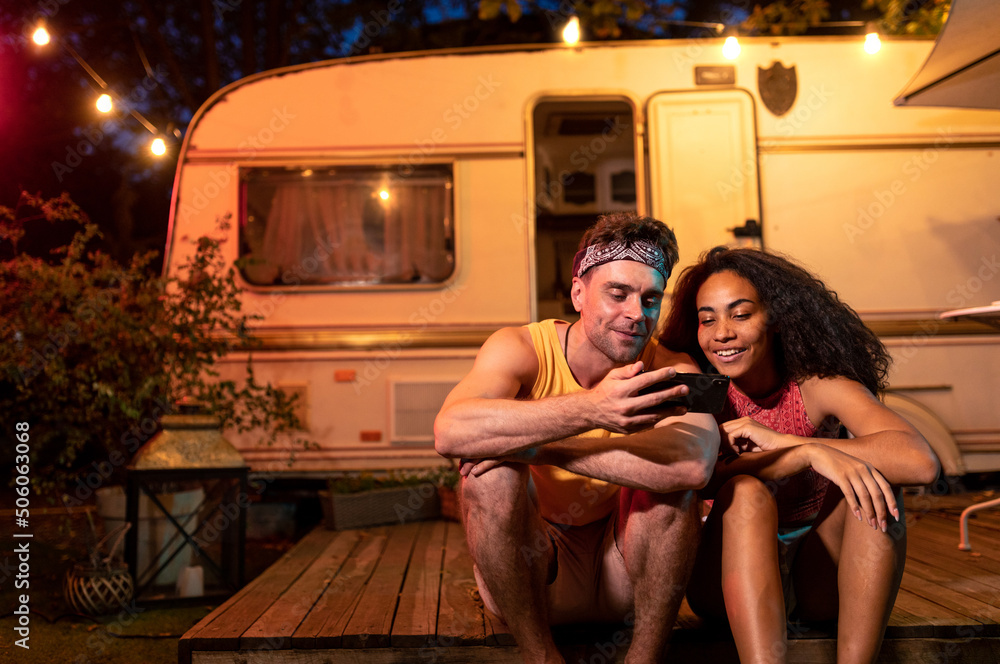 young couple on vacation with the camper - obrazy, fototapety, plakaty 