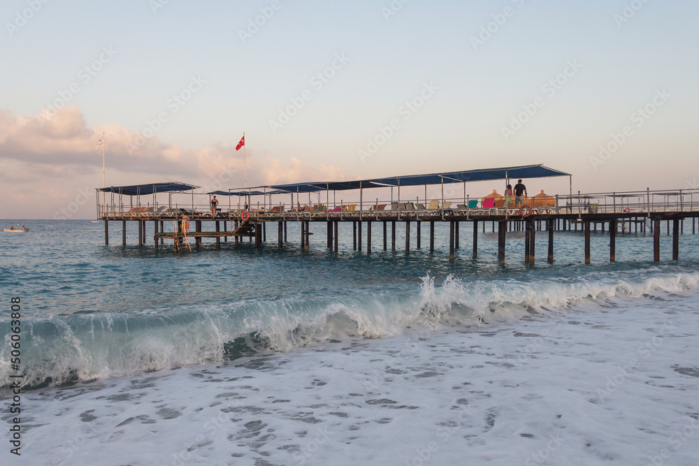 Turkey, 30.08.2021 - Pier on the sea, sea with foam and pier. Bay. Beautiful sea coast in the morning. Journey to the sea