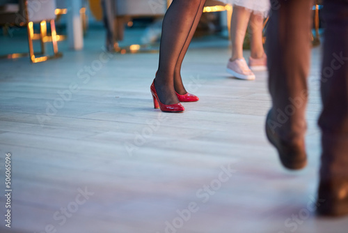 Dancing people on the dance floor. People are dancing, legs close up. Silhouettes of dancing people on the dance floor.   © Alenka