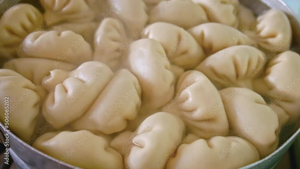 Khinkali are boiled in a saucepan. Selective focus. Khinkali are boiled in a saucepan. Selective focus.