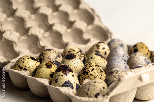 quail eggs in craton eco-friendly packaging photographed from a close distance photo
