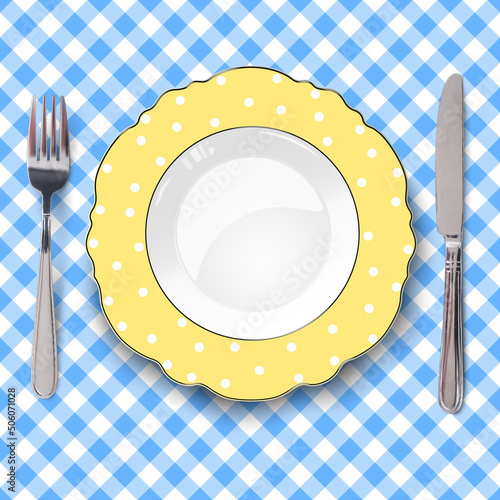 Yellow plate with figured edges and polka dot pattern placed on blue check classic seamless tablecloth. Close up view from above.