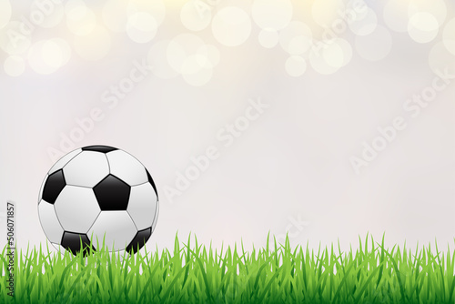 Green football field with football ball. Soccer stadium with realistic ball on blurred bacground.