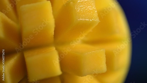 Ripe mango cubes slowly rotate on the table
