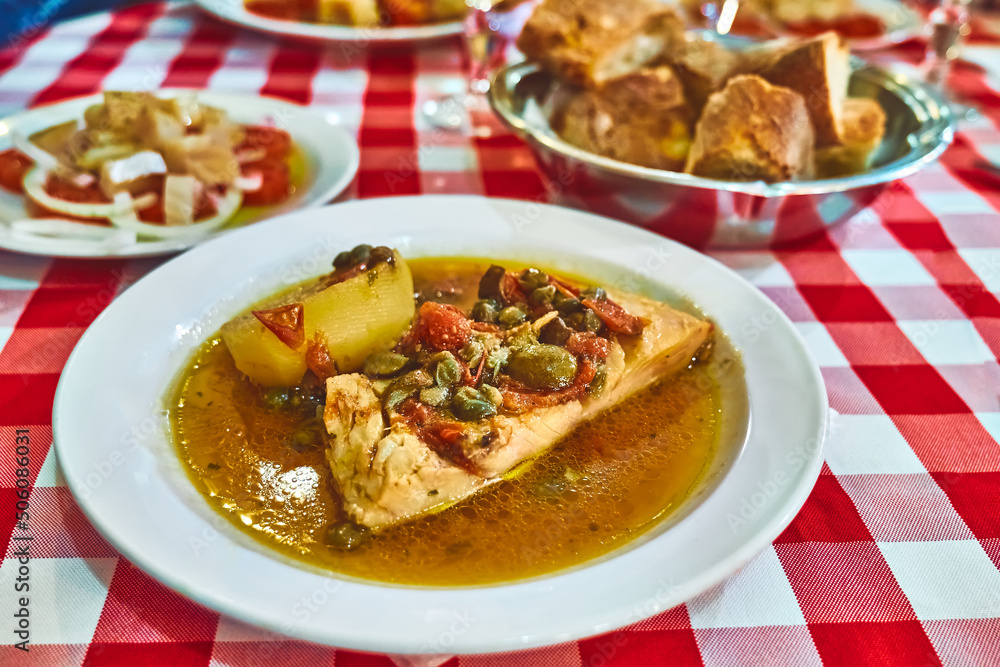 Stockfish (white/ without tomatoes) in Messina style. Cod stewed with cherry tomatoes, caper, olive oil and potato. Traditional plate of Messina, Sicily, Italy Stockfish (white/ without tomatoes) in Messina style. Cod stewed with cherry tomatoes, caper, olive oil and potato. Traditional plate of Messina, Sicily, Italy