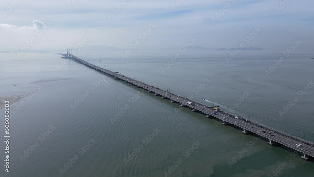 Georgetown, Penang Malaysia - May 18, 2022: The Majestic Penang Bridge, the iconic long bridge connecting Georgetown of Penang Island to the Mainland city of Butterworth. Georgetown, Penang Malaysia - May 18, 2022: The Majestic Penang Bridge, the iconic long bridge connecting Georgetown of Penang Island to the Mainland city of Butterworth.