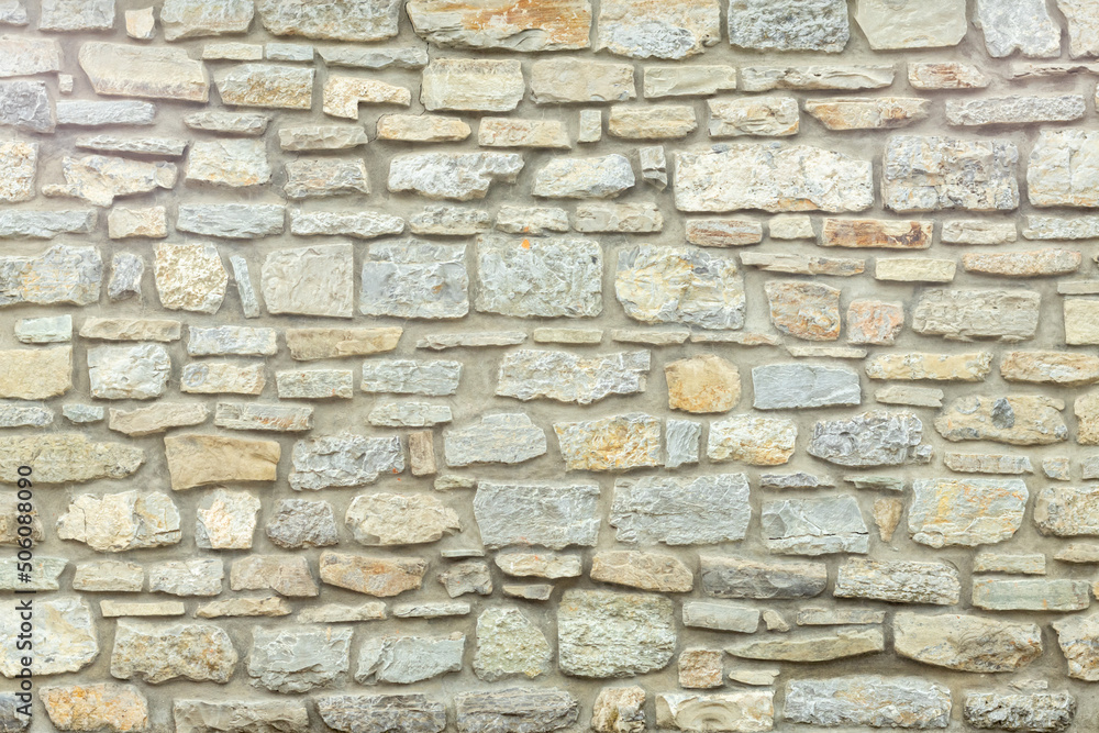 Solid yellow and beige stone wall. Stone background. Solid yellow and beige stone wall. Stone background.