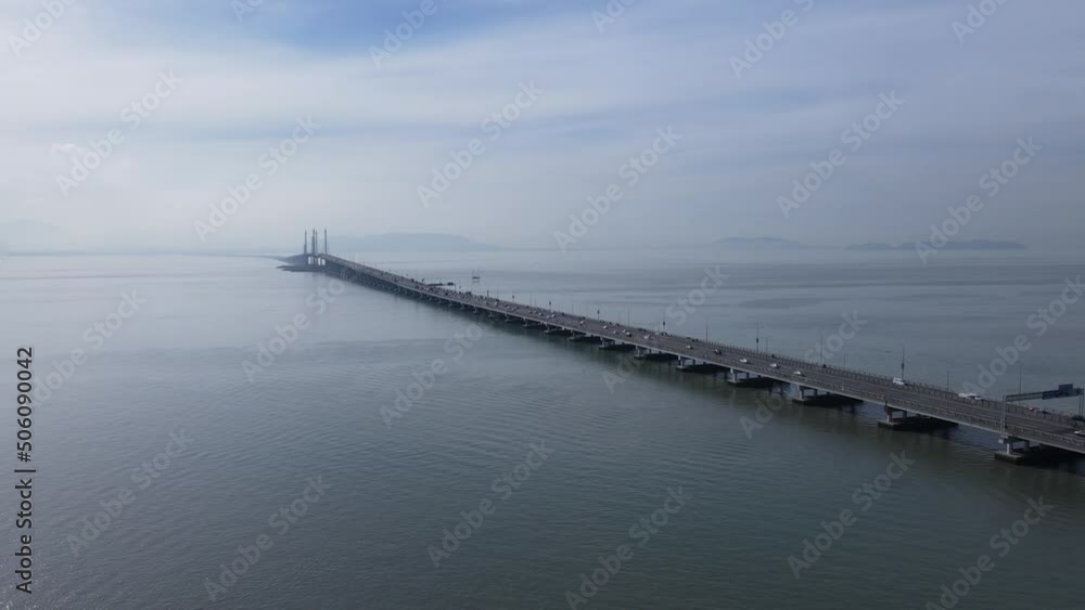 Georgetown, Penang Malaysia - May 18, 2022: The Majestic Penang Bridge, the iconic long bridge connecting Georgetown of Penang Island to the Mainland city of Butterworth. Georgetown, Penang Malaysia - May 18, 2022: The Majestic Penang Bridge, the iconic long bridge connecting Georgetown of Penang Island to the Mainland city of Butterworth.