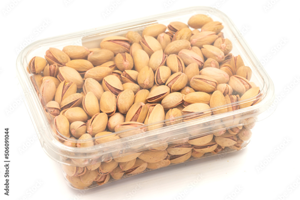 Packed pistachio nuts isolated on white background. Organic nuts. close up Packed pistachio nuts isolated on white background. Organic nuts. close up