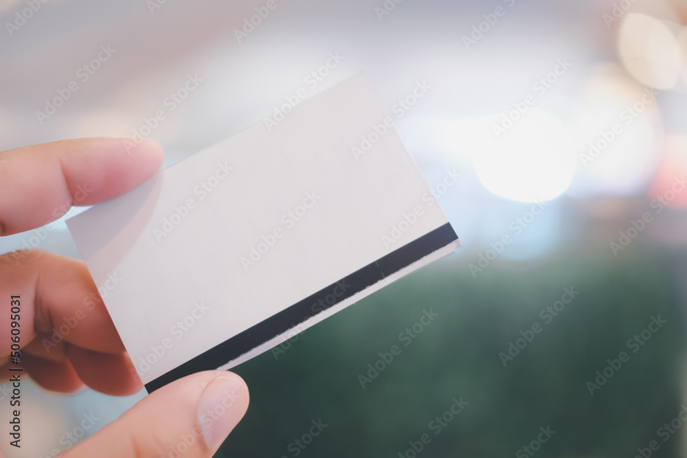 Young man's hand holding a paper ticket. Young man's hand holding a paper ticket.