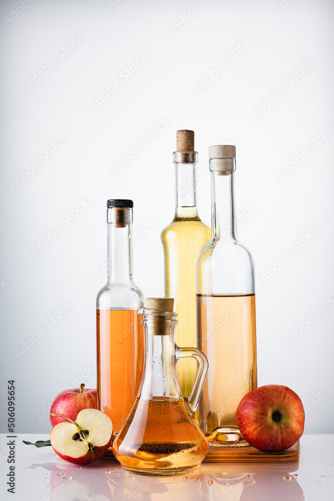 Bottled apple cider vinegar and fresh apples. Bottled apple cider vinegar and fresh apples.