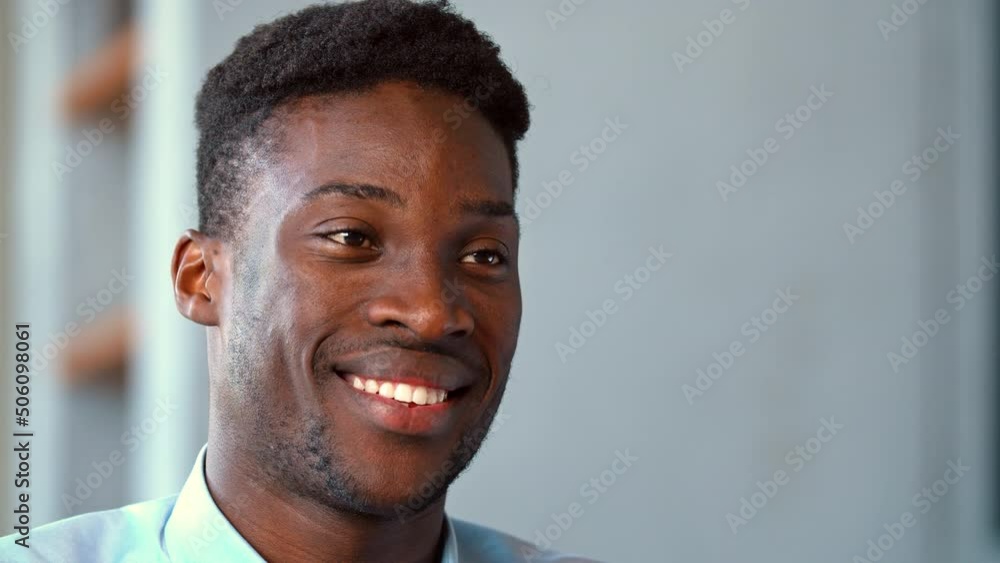 Portrait of a smiling young man looking away, slow motion Portrait of a smiling young man looking away, slow motion