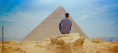 Fotografie, Obraz A man in front of the pyramids of Giza. Egypt