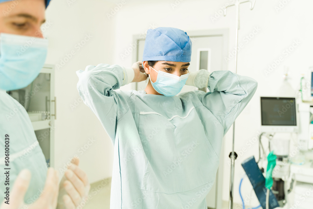 Female surgeon preparing for surgery Female surgeon preparing for surgery