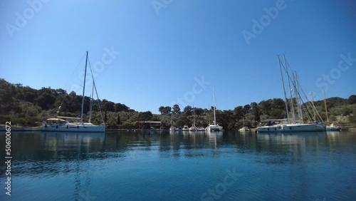 flying over the water with a view of the yachts in the bay