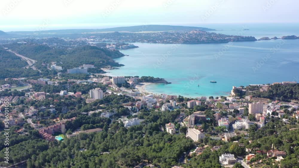 Aerial orbiting shot flying around Peguera from mountain side with hotels and beaches. Sea in background. Mallorca, Balearic Islands, Spain Aerial orbiting shot flying around Peguera from mountain side with hotels and beaches. Sea in background. Mallorca, Balearic Islands, Spain