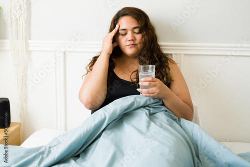 Stressed woman feeling sick because of a hangover photo