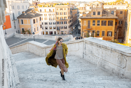 Canvas Print Woman running on famous Spanish steps on background of old town in Rome