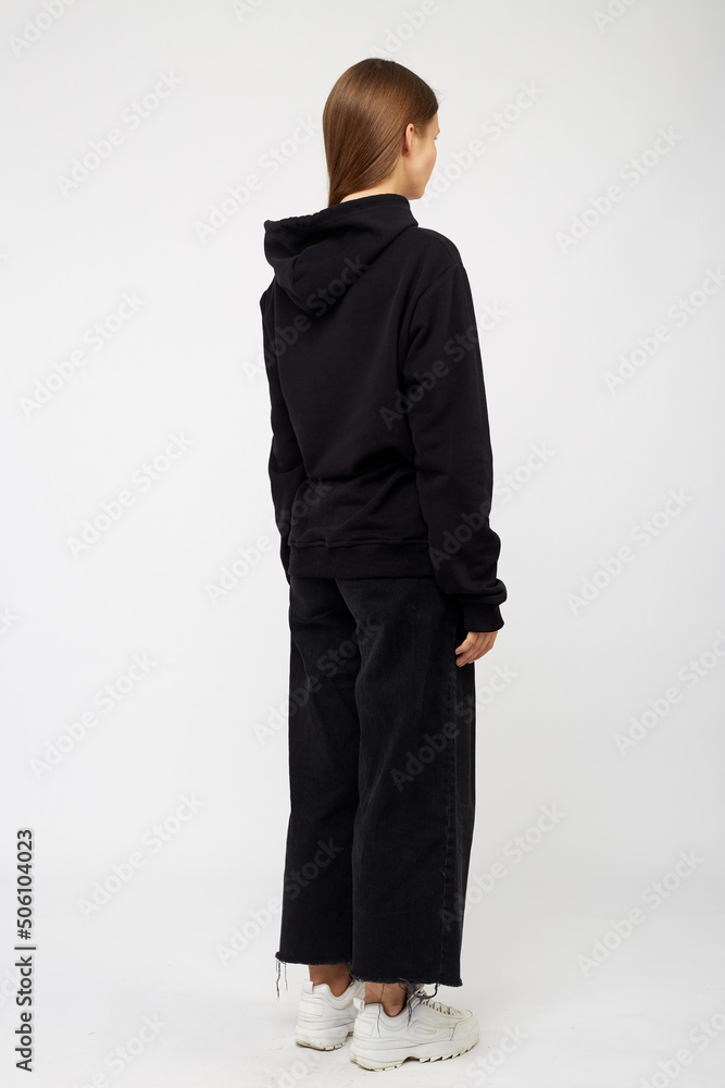 Portrait of young woman wearing black hoodie, isolated studio image on white background Portrait of young woman wearing black hoodie, isolated studio image on white background