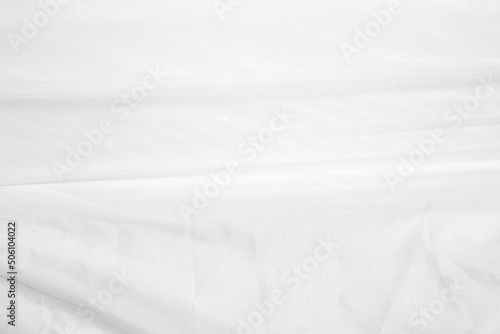 Textures Background Abstract white fabric background pattern with soft waves is suitable for a dress or suit where transparency and flow are required. © buraratn