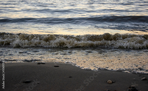 background sandy beach with waves and rocks