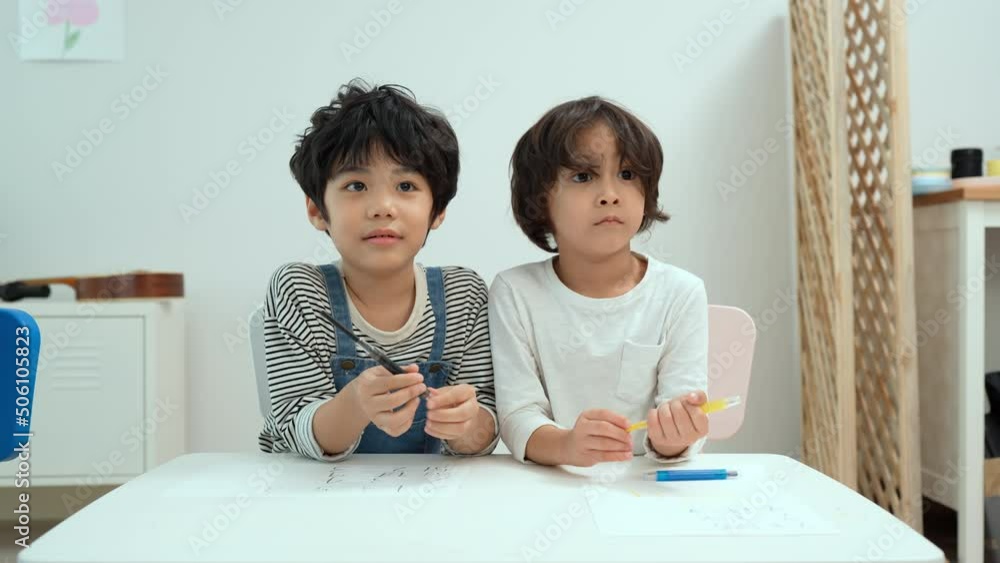 Happy asian two boy kids creatively draw and talk with brushes and crayon on the table. Little boy kindergarten preschool student in class.First time to school education,Childhood education concept. Happy asian two boy kids creatively draw and talk with brushes and crayon on the table. Little boy kindergarten preschool student in class.First time to school education,Childhood education concept.