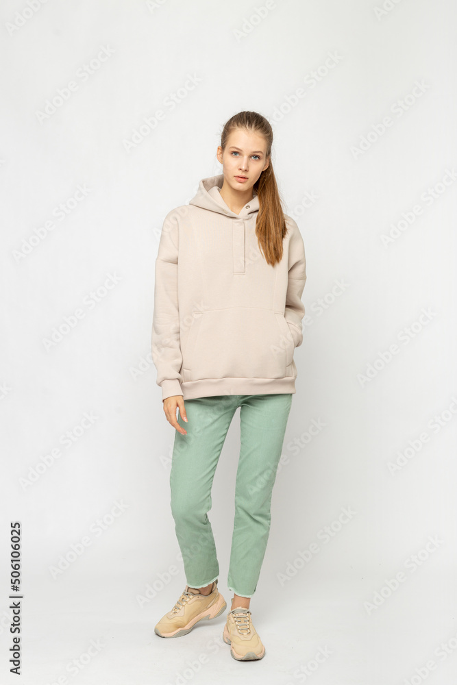 Girl in green cargo pants and beige hoodie isolated on white Girl in green cargo pants and beige hoodie isolated on white