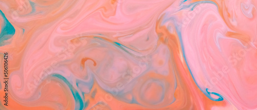 Peach coral color background. Fluid art texture with coral color. Abstract background with multicolored spots on liquid