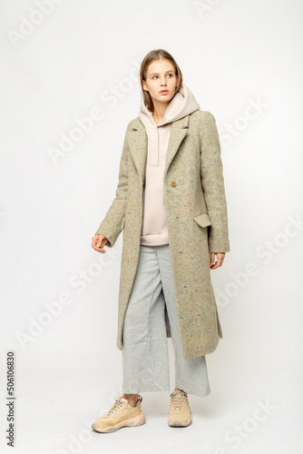 Girl in a beige coat isolated on white background