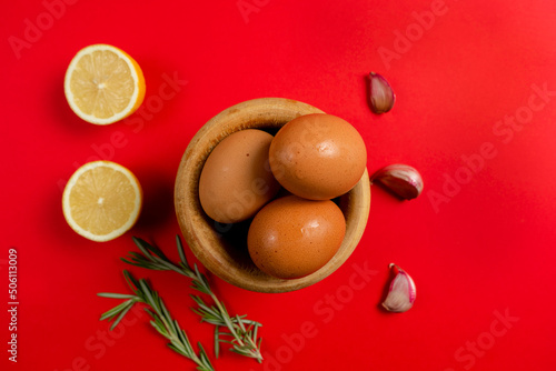 Top view of eggs, lemons and garlic ingredients needed to make the rich homemade alioli sauce typical Spanish sauce photo