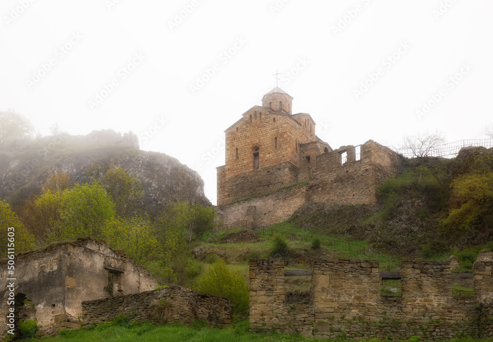 Ancient Shoana Church of the 10th century in the mountains in dense fog