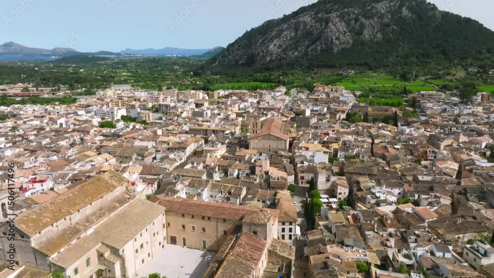 Aerial view of Pollenca, Mallorca, Spain. Small town with a view into a green and rocky landscape. Aerial view of Pollenca, Mallorca, Spain. Small town with a view into a green and rocky landscape.