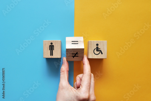 an image of an expensive person and a disabled person and an equal sign between them. Equality and acceptance of persons with disabilities photo