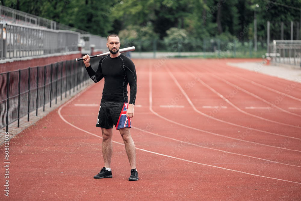 Fototapeta premium handsome sexy man with baseball bat on the sports field