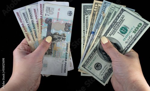 Russian rubles and dollars in hands on a black background