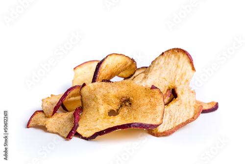 Dehydrated apple slices with cinnamon and sugar sprinkles over white.