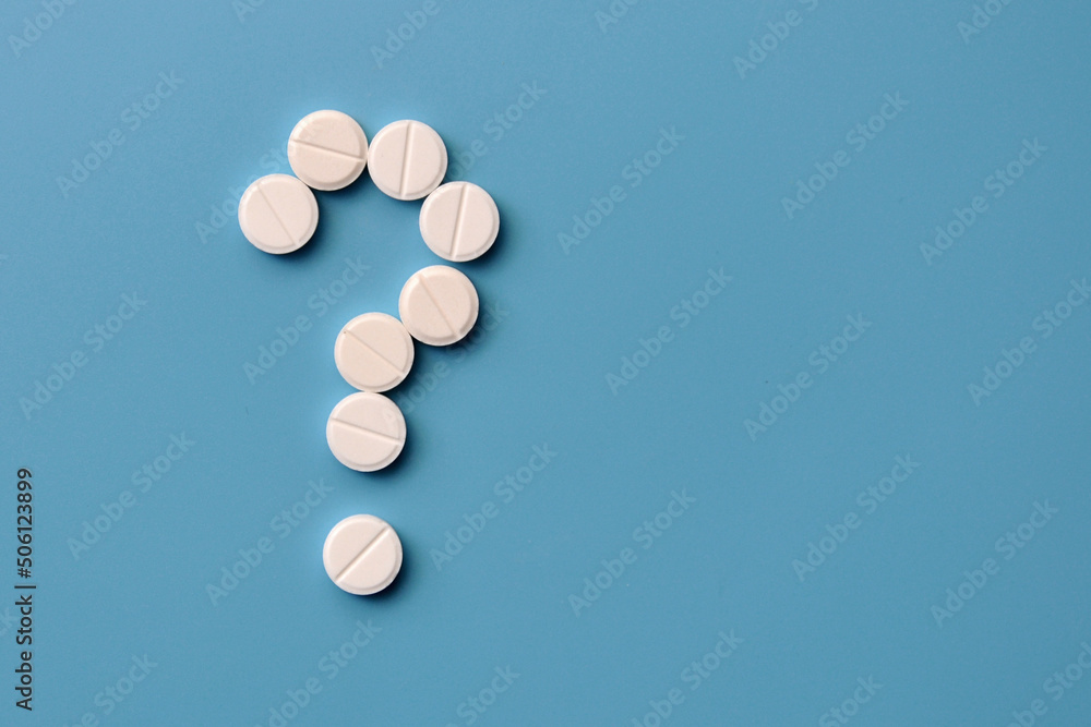 A question mark from pills. Symbol of questions on diagnosis and treatment