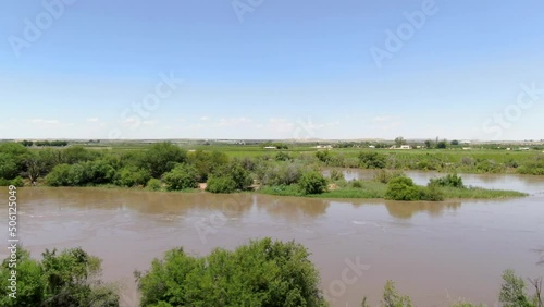 Jib up reveals flooded Orange River flowing between lush green grapevines fields photo