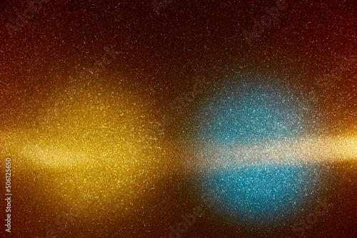 On a gradient dark yellow background in fine grain  blue and yellow clouds of light