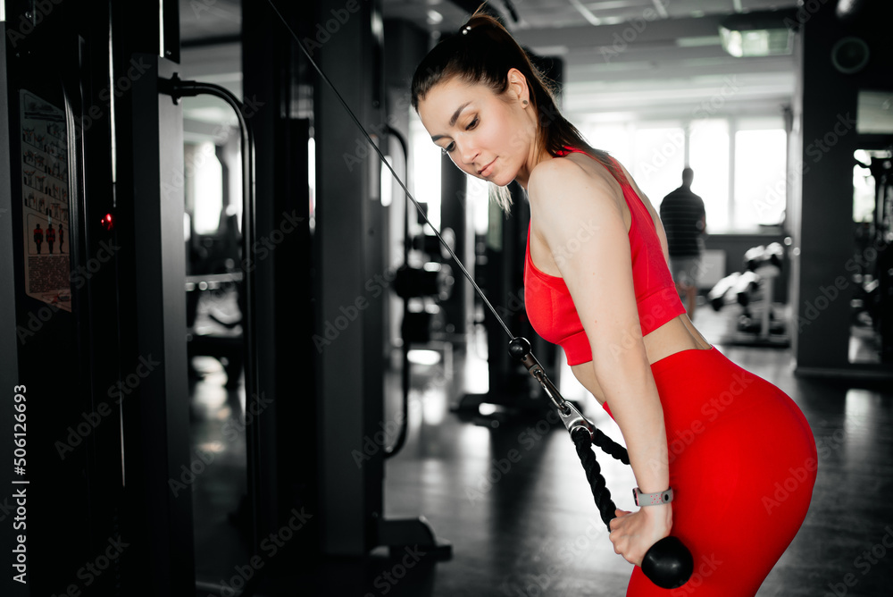 Woman doing triceps exercise in the gym